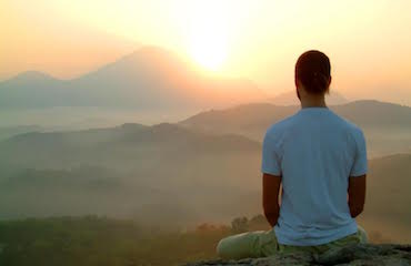 man-watching-sunset-and-meditating-.jpg